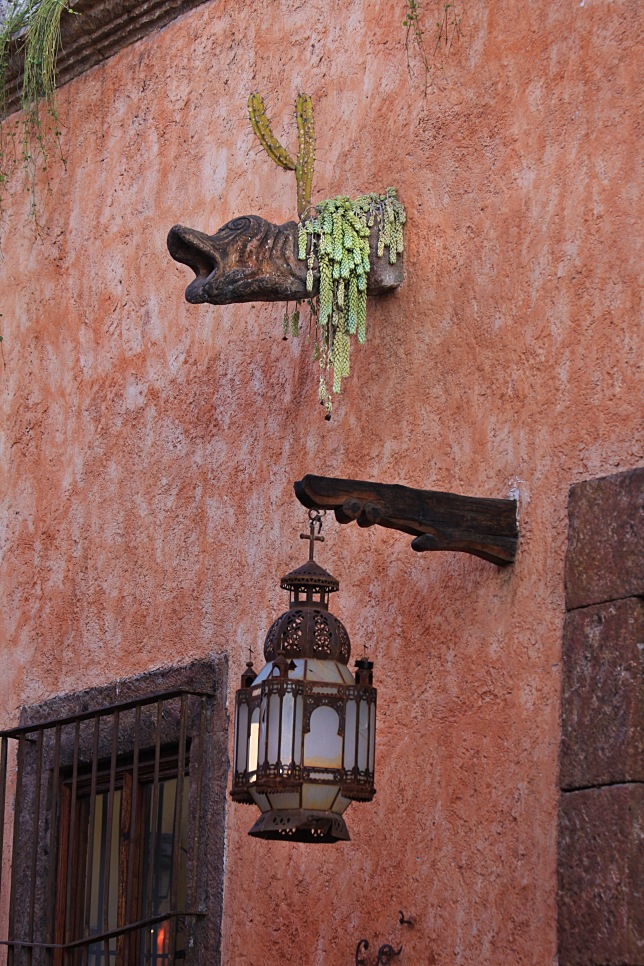 Gargoyle with cactus growing out of it
